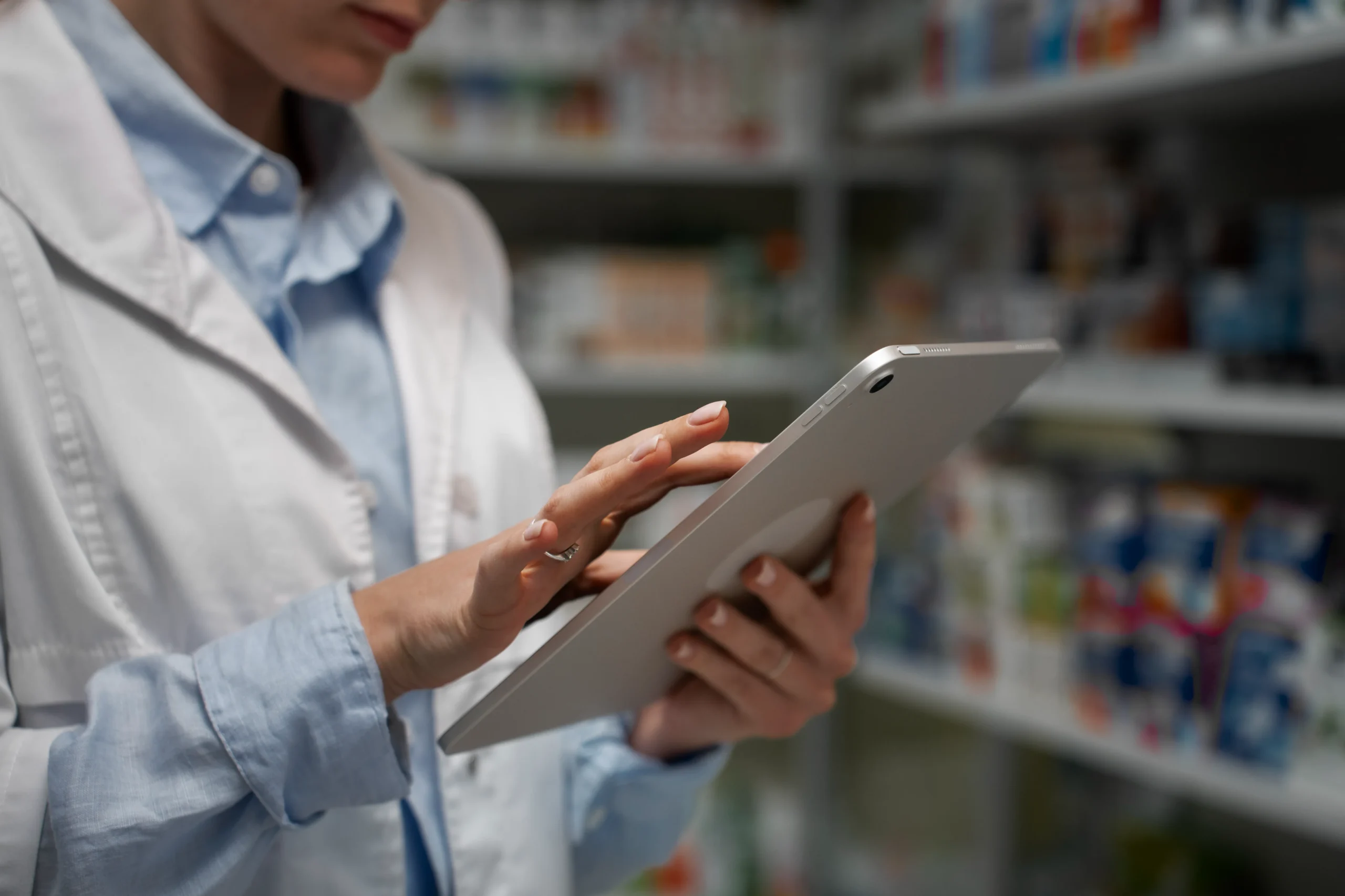 Pharma researcher uses tablet for data analytics in pharma and pharma data management.