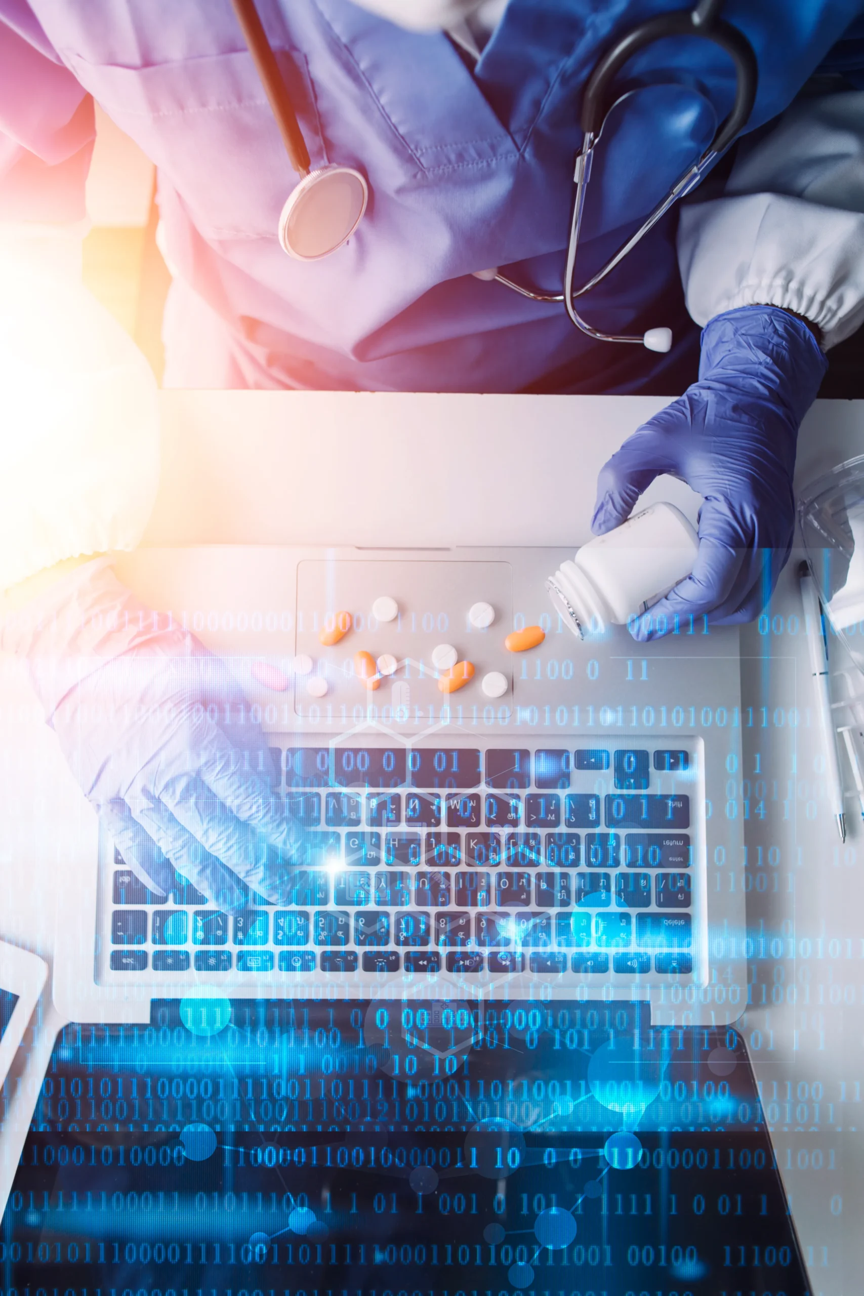 Healthcare provider using a digital drug database on a laptop to review medication data.