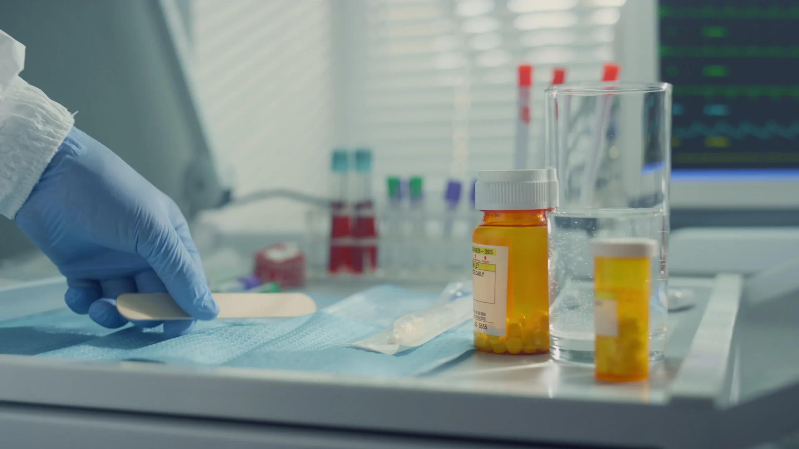 Laboratory equipment and pill bottles on a tray representing open source DrugBank alternatives.