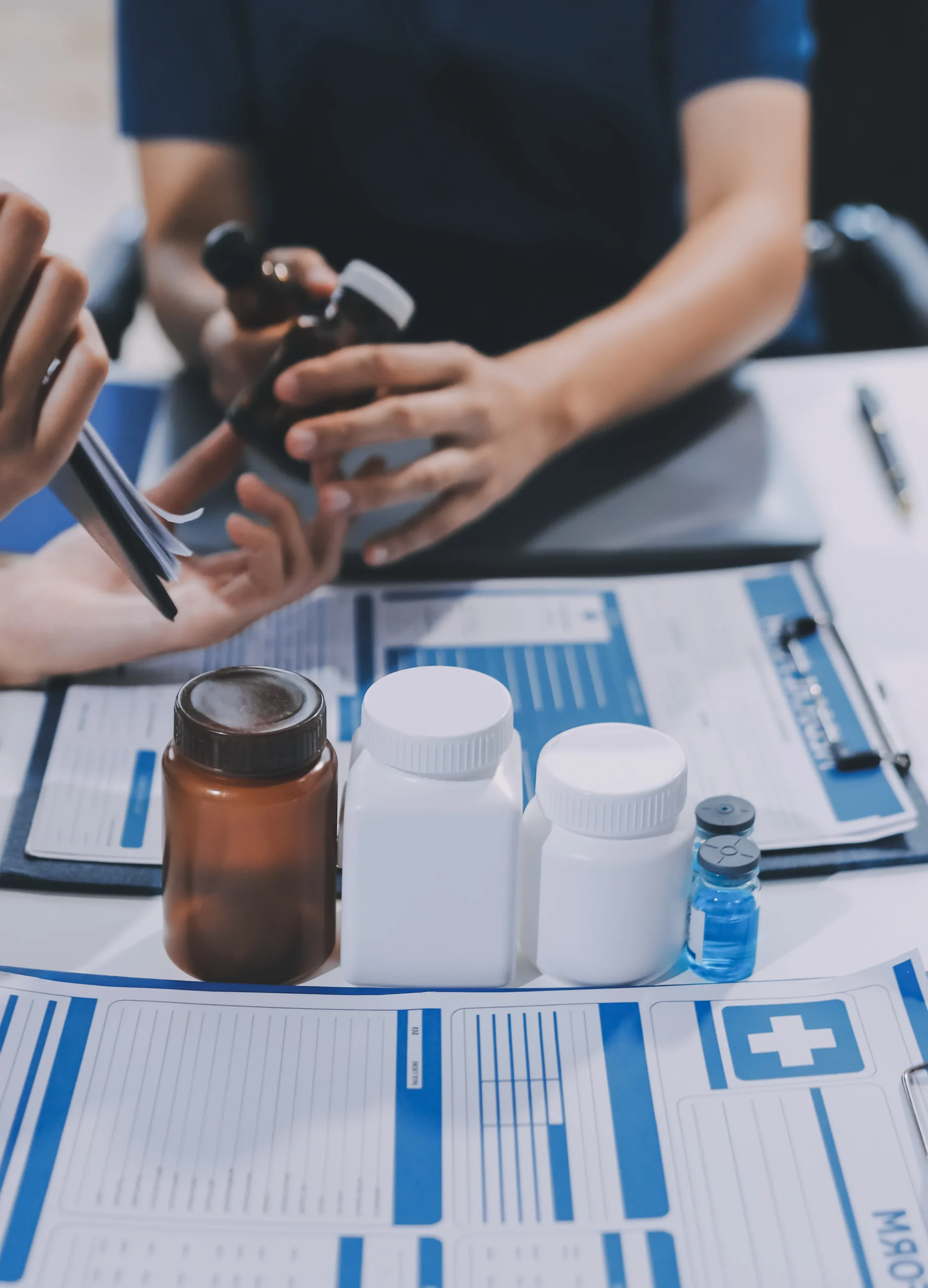 Prescription bottles and clinical forms aligned with automated data verification from a medication database API.