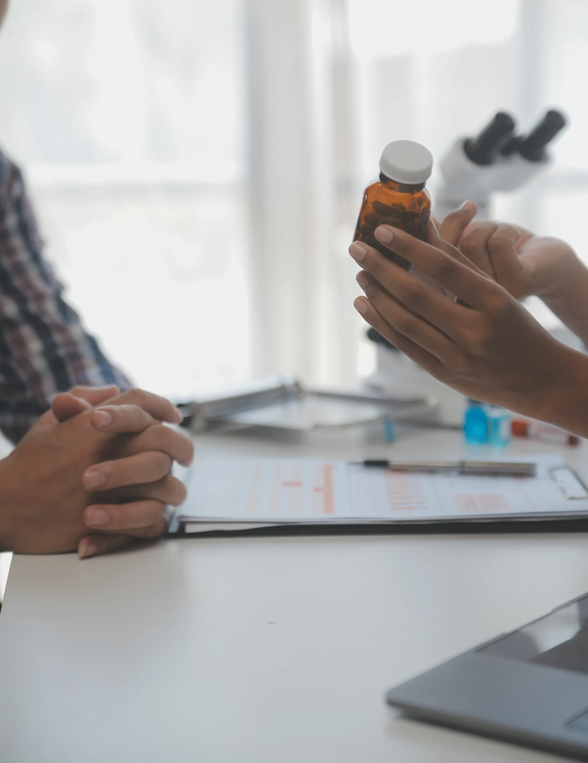 Provider verifying prescription bottle details against patient health records powered by a drug database API.